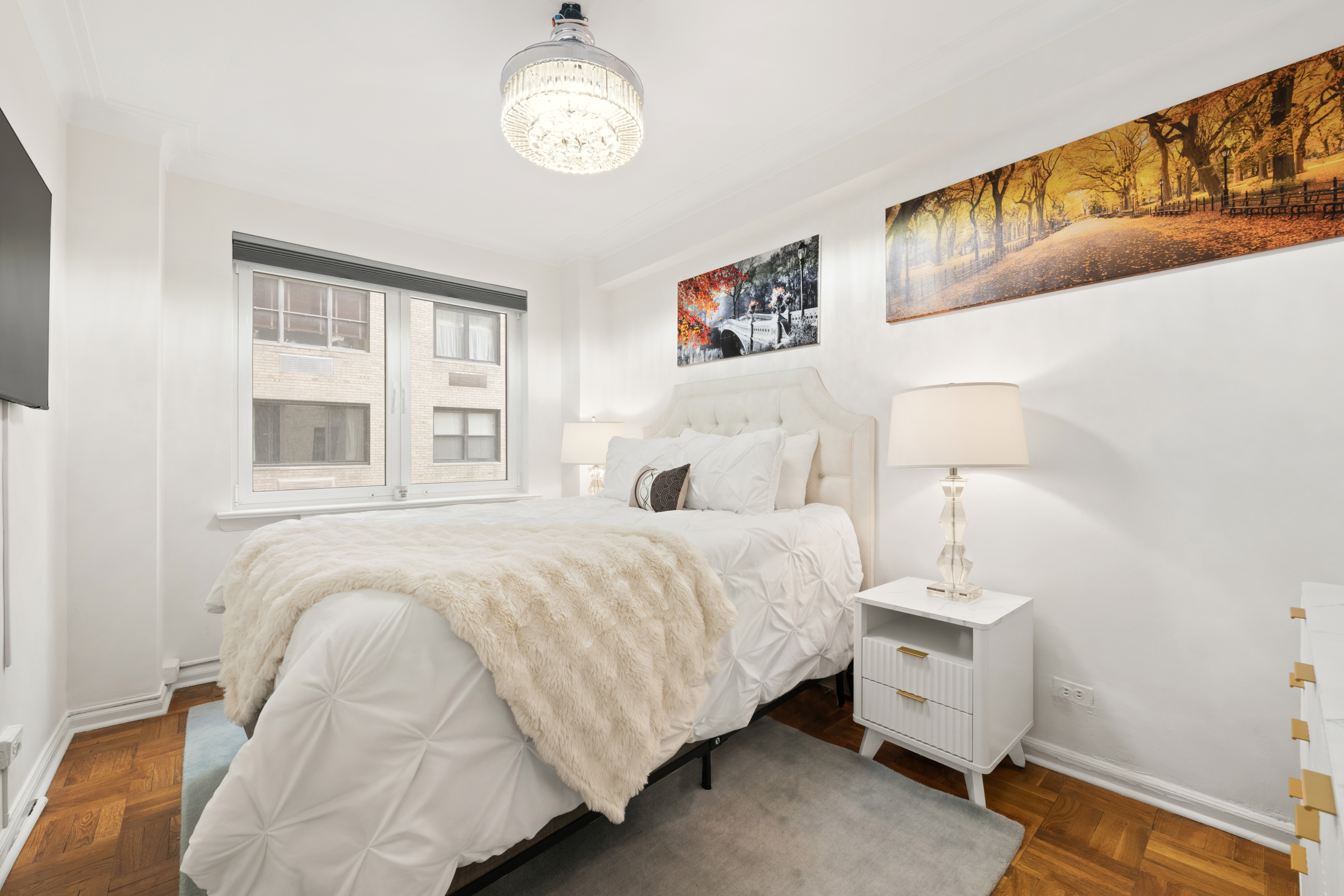 860 5th Avenue, Unit 5L Manhattan, NY 10065 - Photo 6 of 12 a bedroom with a bed and a window