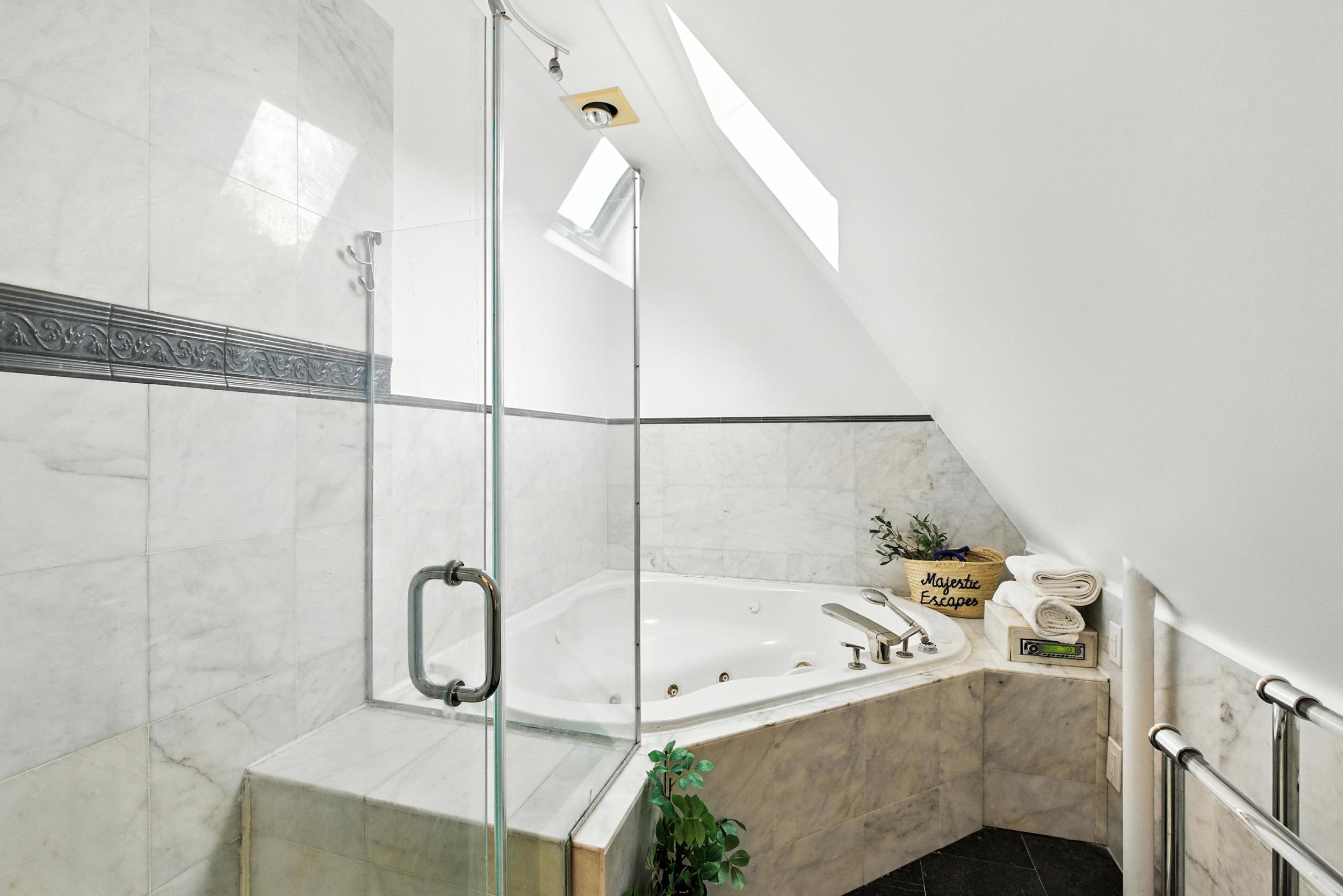1070 East 13th Street Brooklyn, NY 11230 - Photo 6 of 18 a bathroom with a bathtub and shower