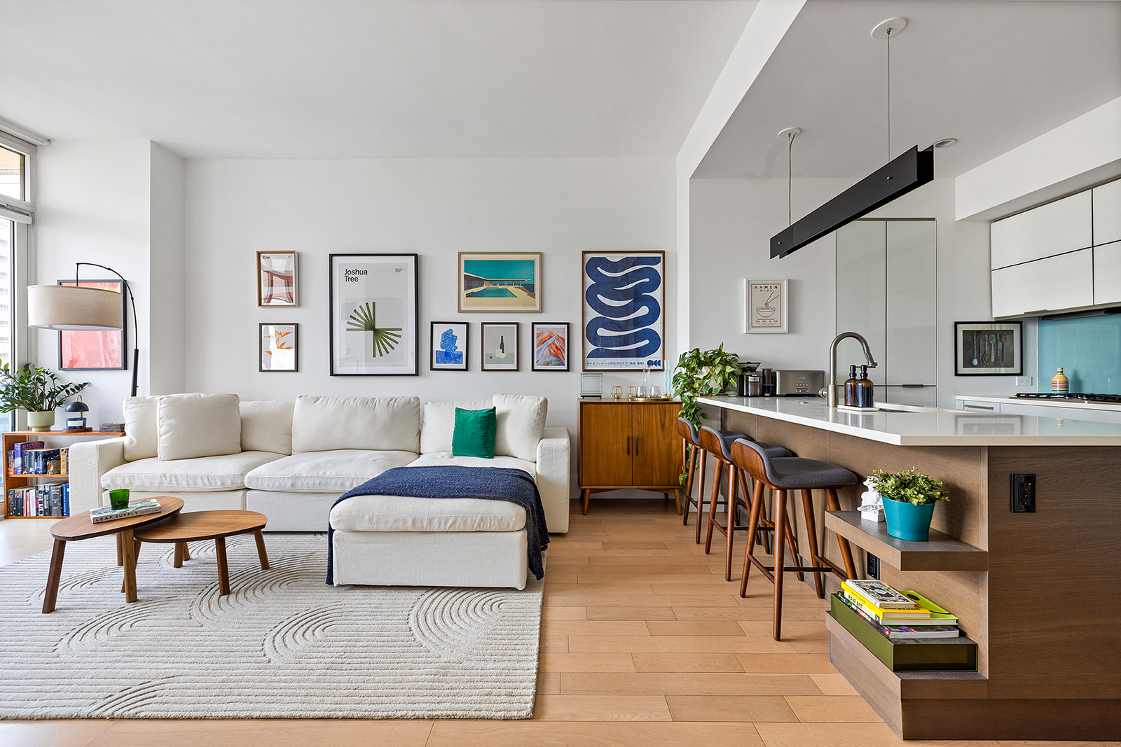 a living room with furniture and a kitchen view