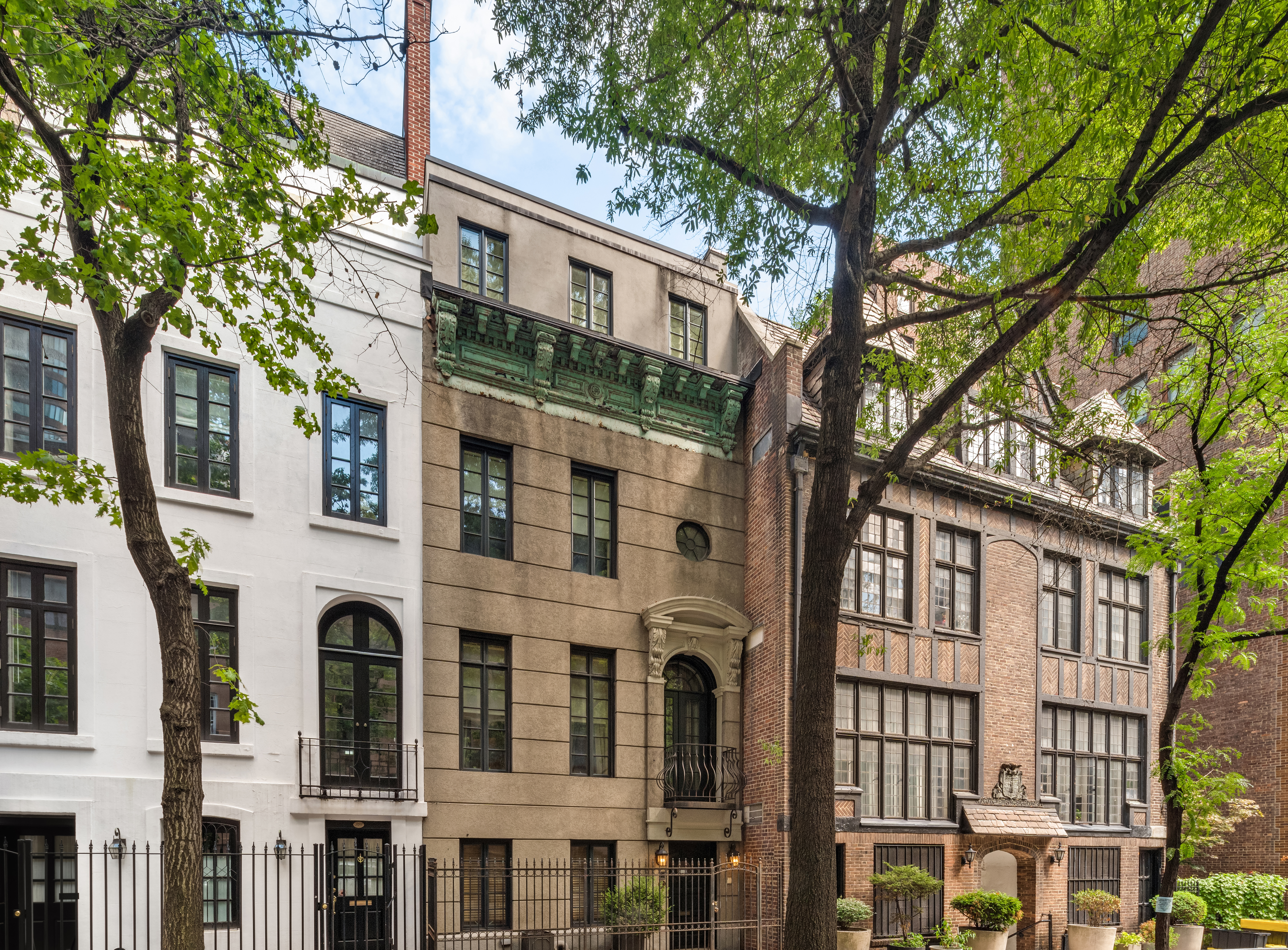 a front view of a building with a tree