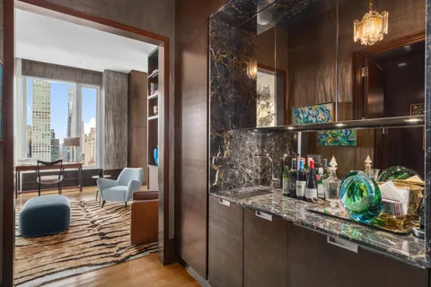 a dining room with furniture and a floor to ceiling window