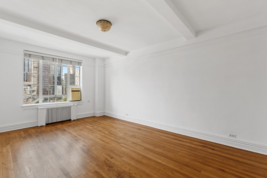 101 Lafayette Avenue, Unit 12L Brooklyn, NY 11217 - Photo 3 of 7 an empty room with wooden floor and windows