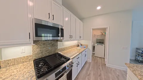 a kitchen with a stove and a microwave