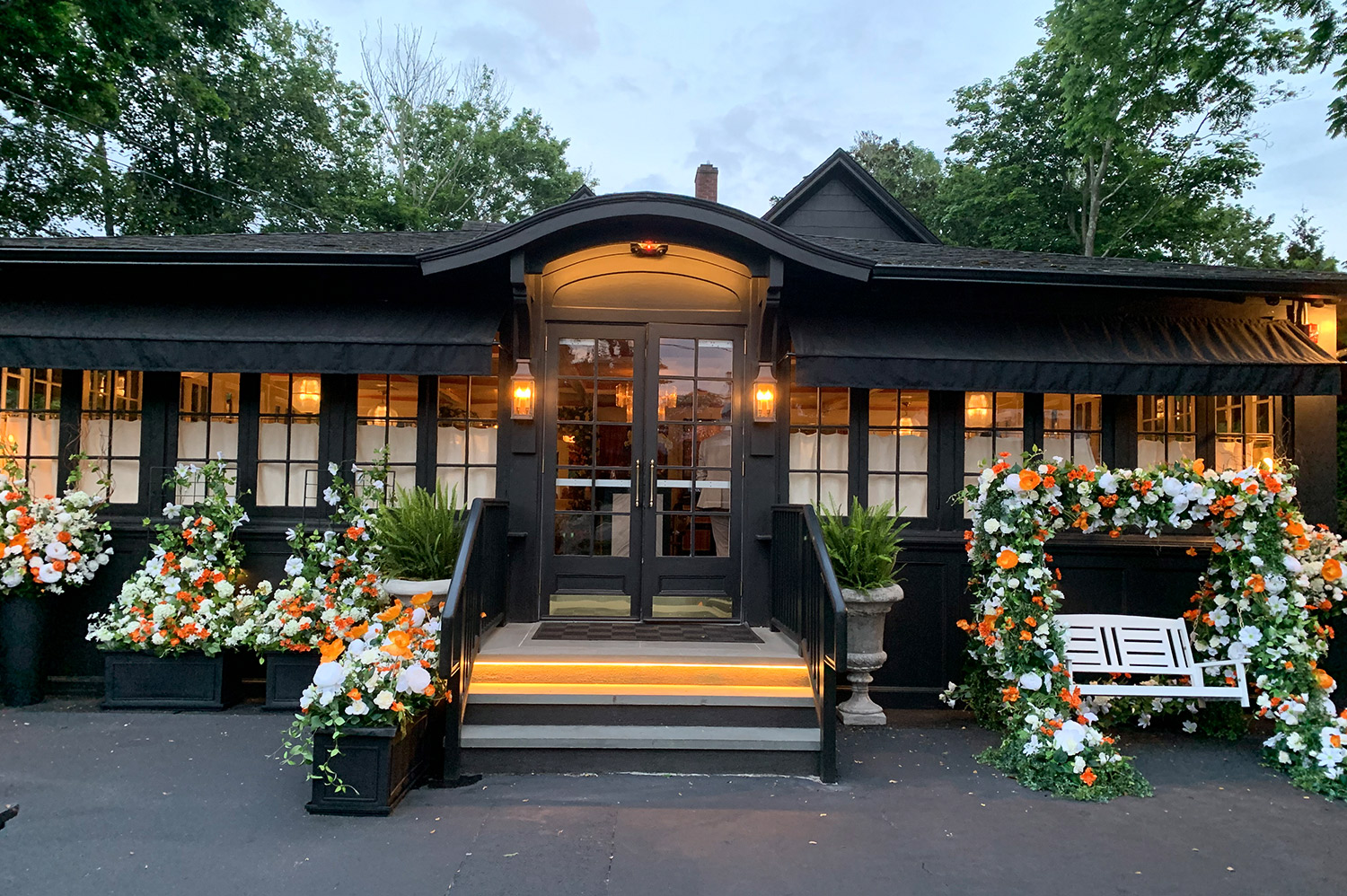 210 Hampton Road Southampton, NY 11968 - Photo 2 of 34 a front view of a house with outdoor seating and a garden