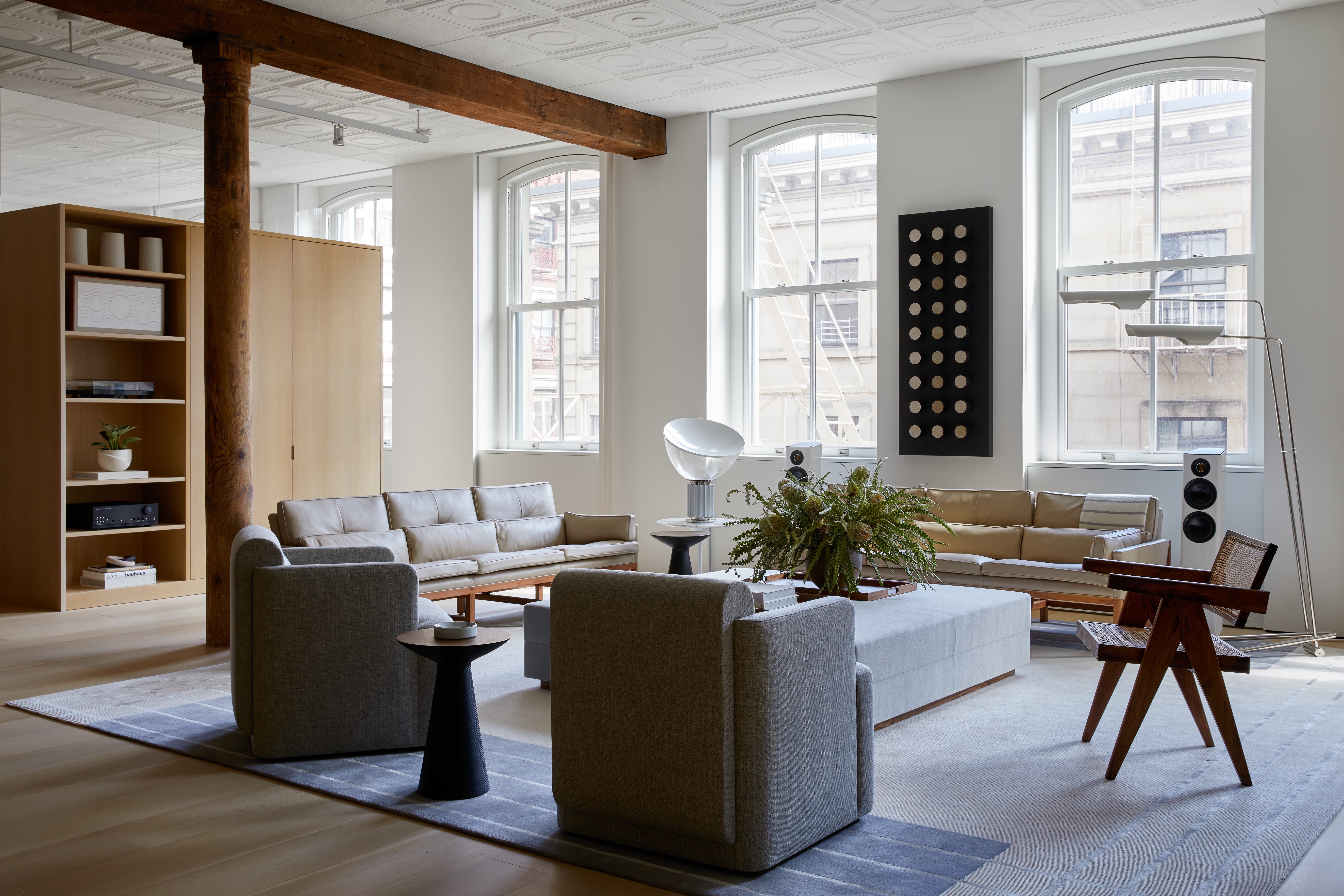100 Grand Street, Unit 4 Manhattan, NY 10013 - Photo 2 of 13 a living room with furniture and a large window