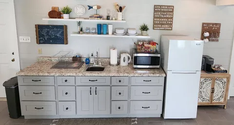a kitchen with stainless steel appliances granite countertop a refrigerator and a cabinets