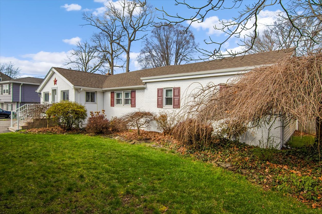 107 Kingston Road Parsippany, NJ 07054 - Photo 34 of 43 a front view of a house with a garden