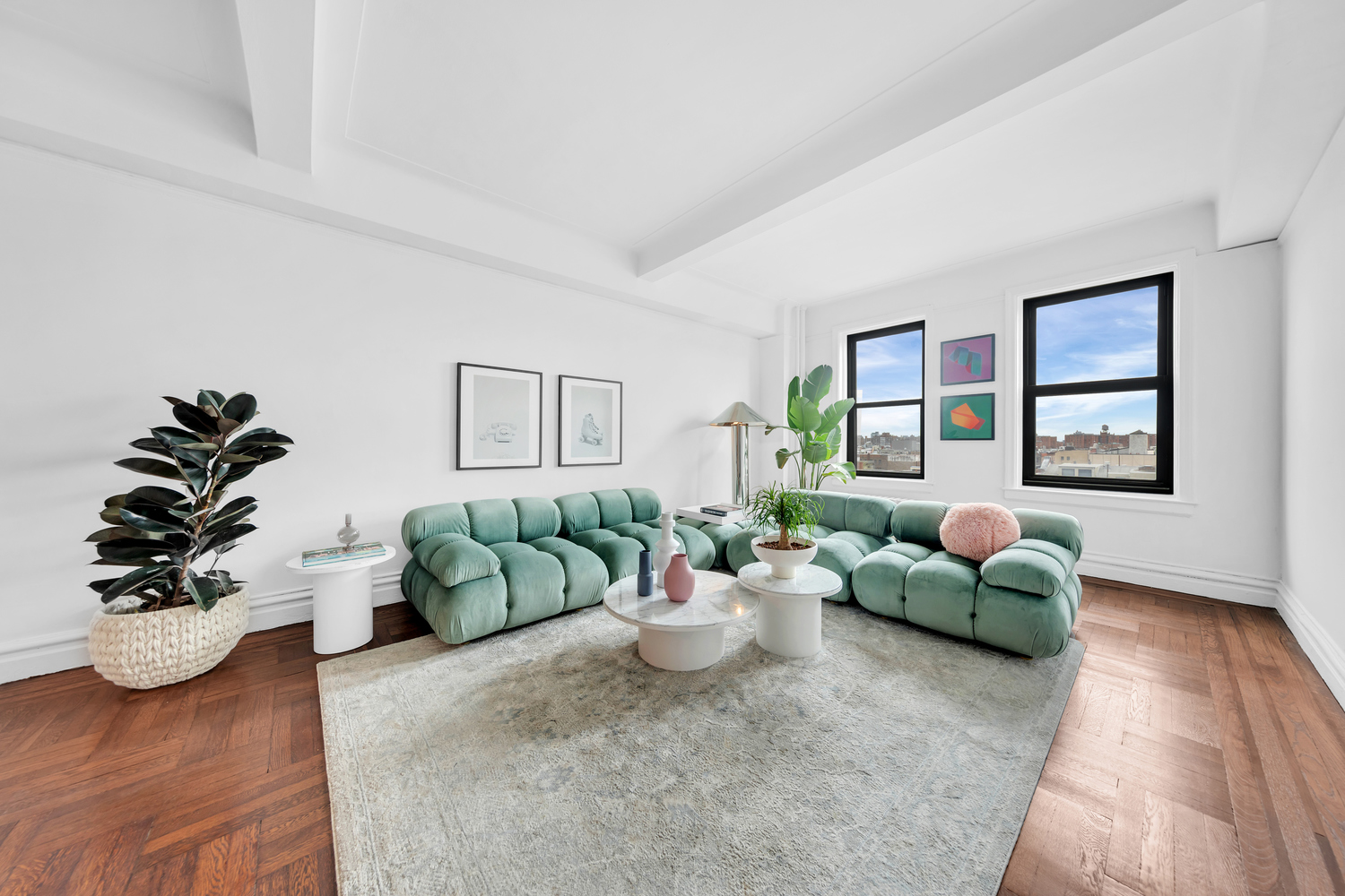 172 East 4th Street, Unit 8F Manhattan, NY 10009 - Photo 2 of 11 a living room with furniture and a potted plant