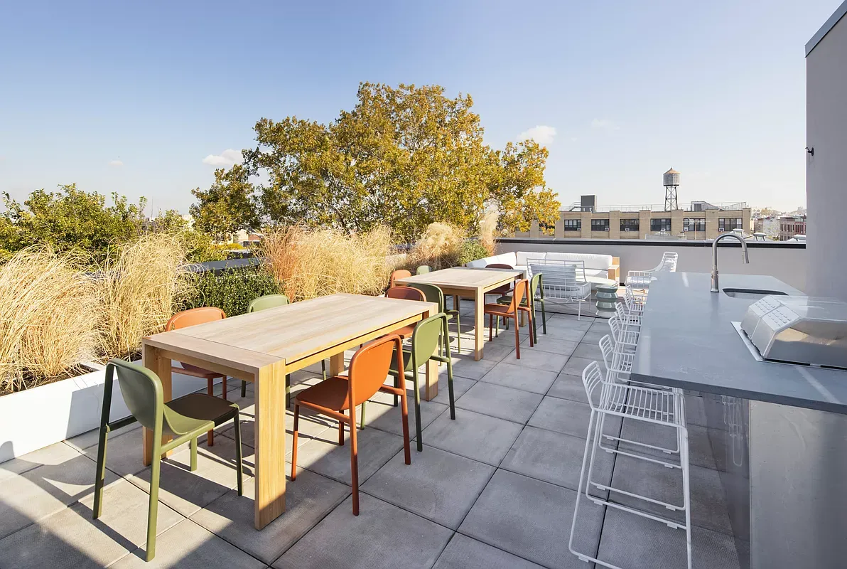 a outdoor dining space with furniture and city view