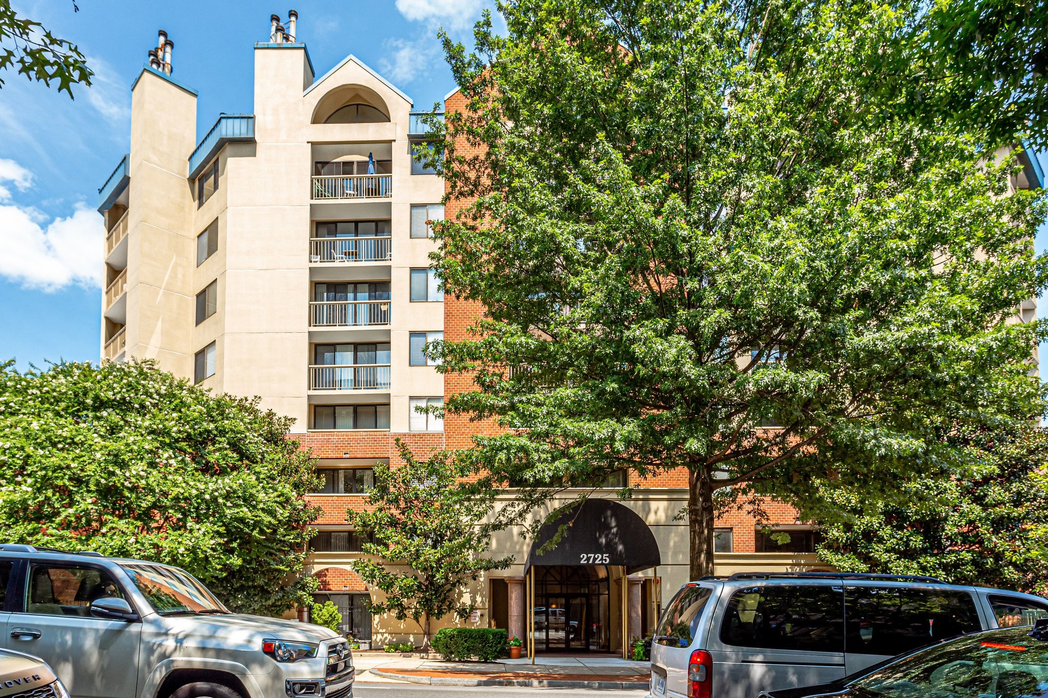 2725 Connecticut Avenue Northwest, Unit 507 Washington, DC 20008 - Photo 2 of 31 a front view of a building with lot of cars and trees