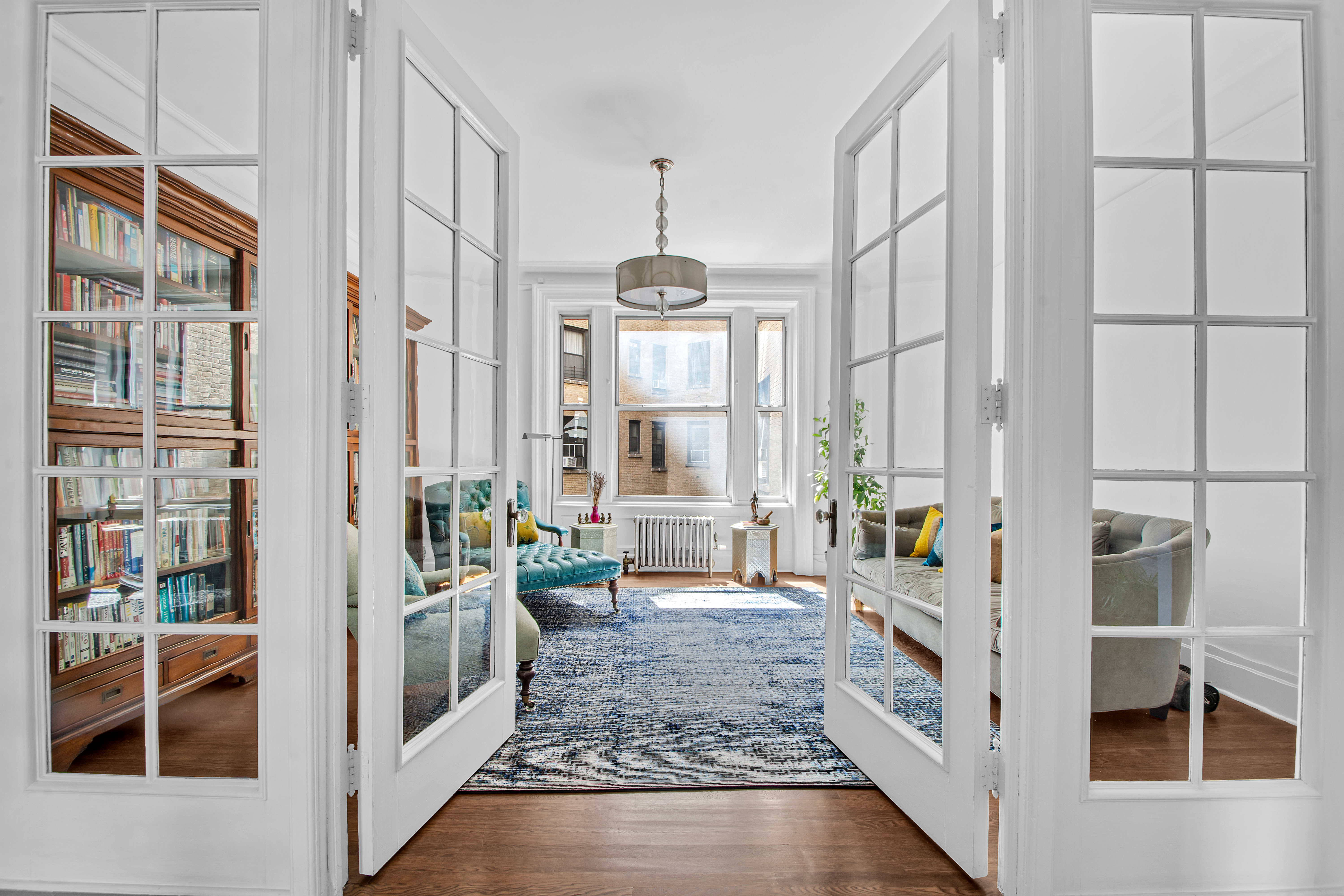 800 Riverside Drive, Unit 2E Manhattan, NY 10032 - Photo 3 of 27 a very nice looking room with a large window and chandelier