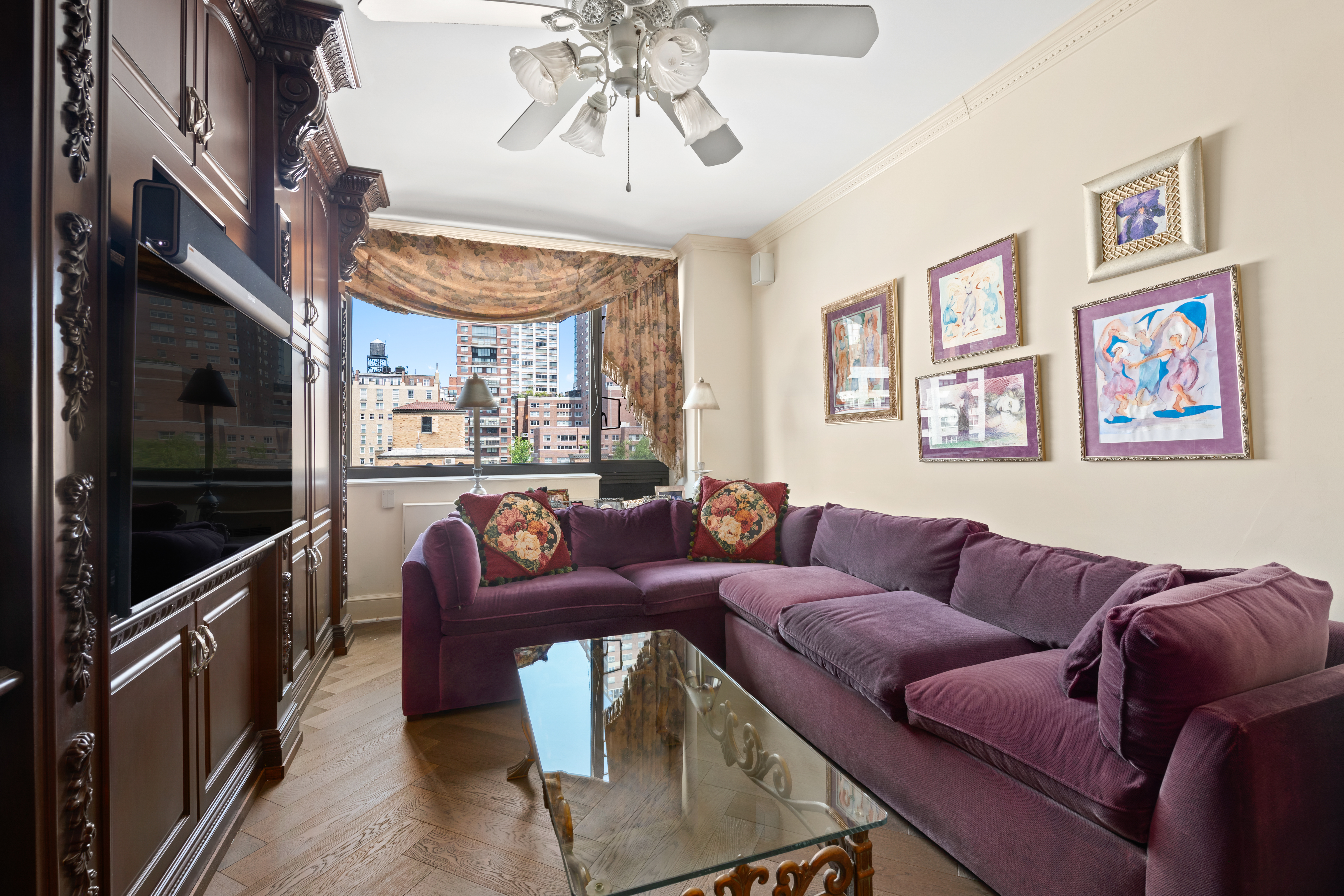 333 East 69th Street, Unit 10J Manhattan, NY 10021 - Photo 4 of 12 a living room with furniture and a flat screen tv