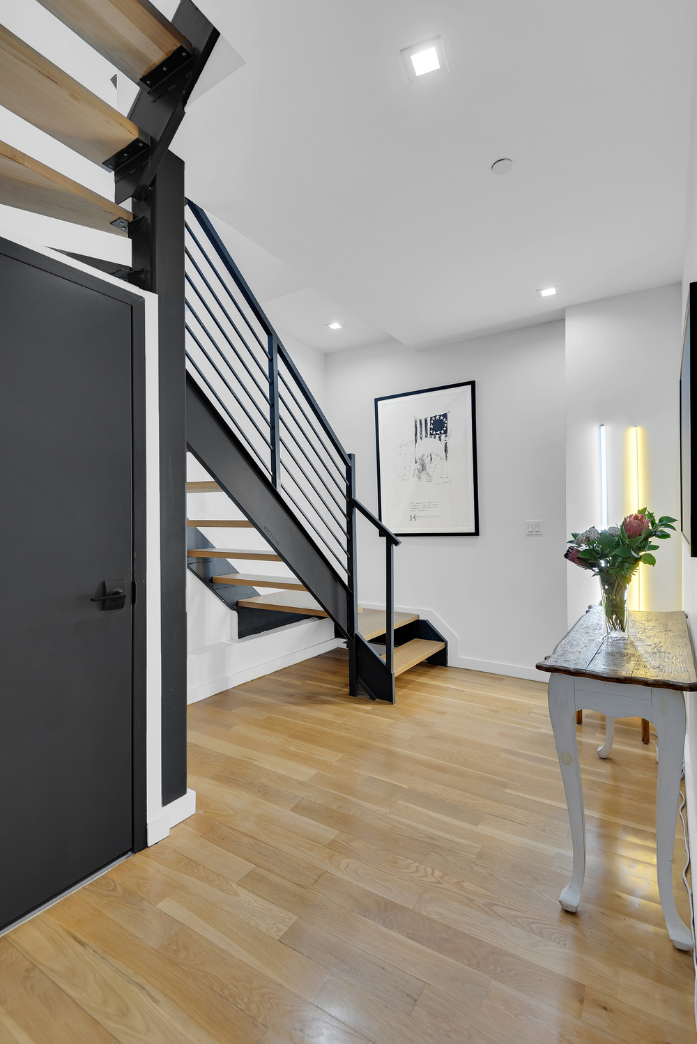267 Evergreen Avenue, Unit PH Brooklyn, NY 11221 - Photo 8 of 19 a view of a hallway with wooden floor and stairs