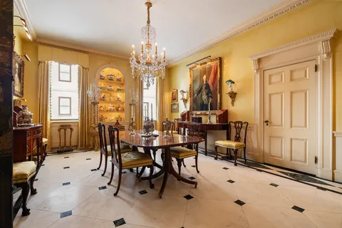 a view of a dining room with furniture and chandelier