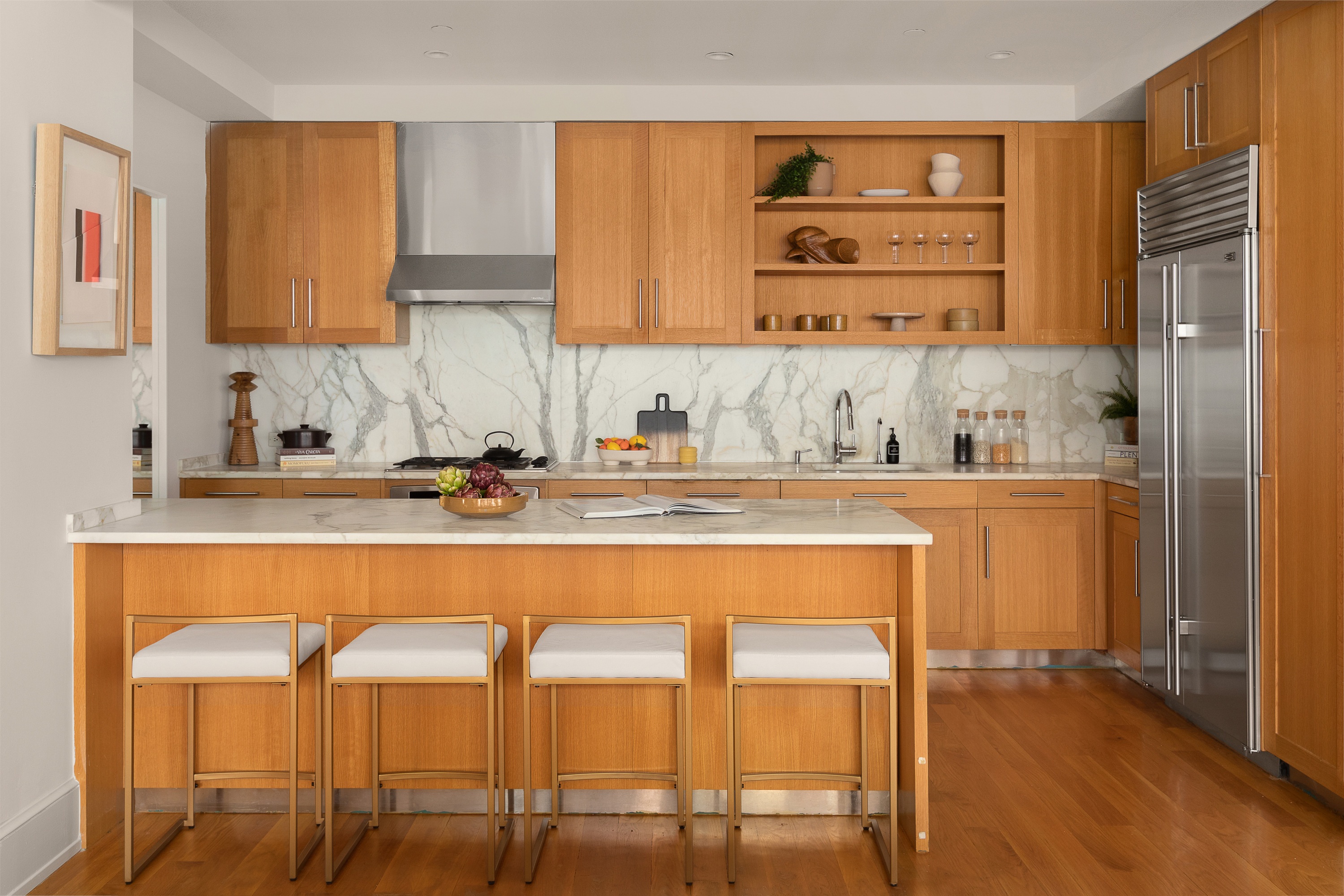 130 West 30th Street, Unit 4C Manhattan, NY 10001 - Photo 4 of 15 a kitchen with a table chairs sink and cabinets