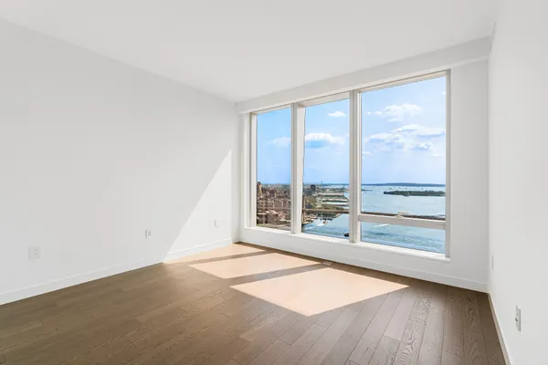 a bedroom with a large bed and a large window