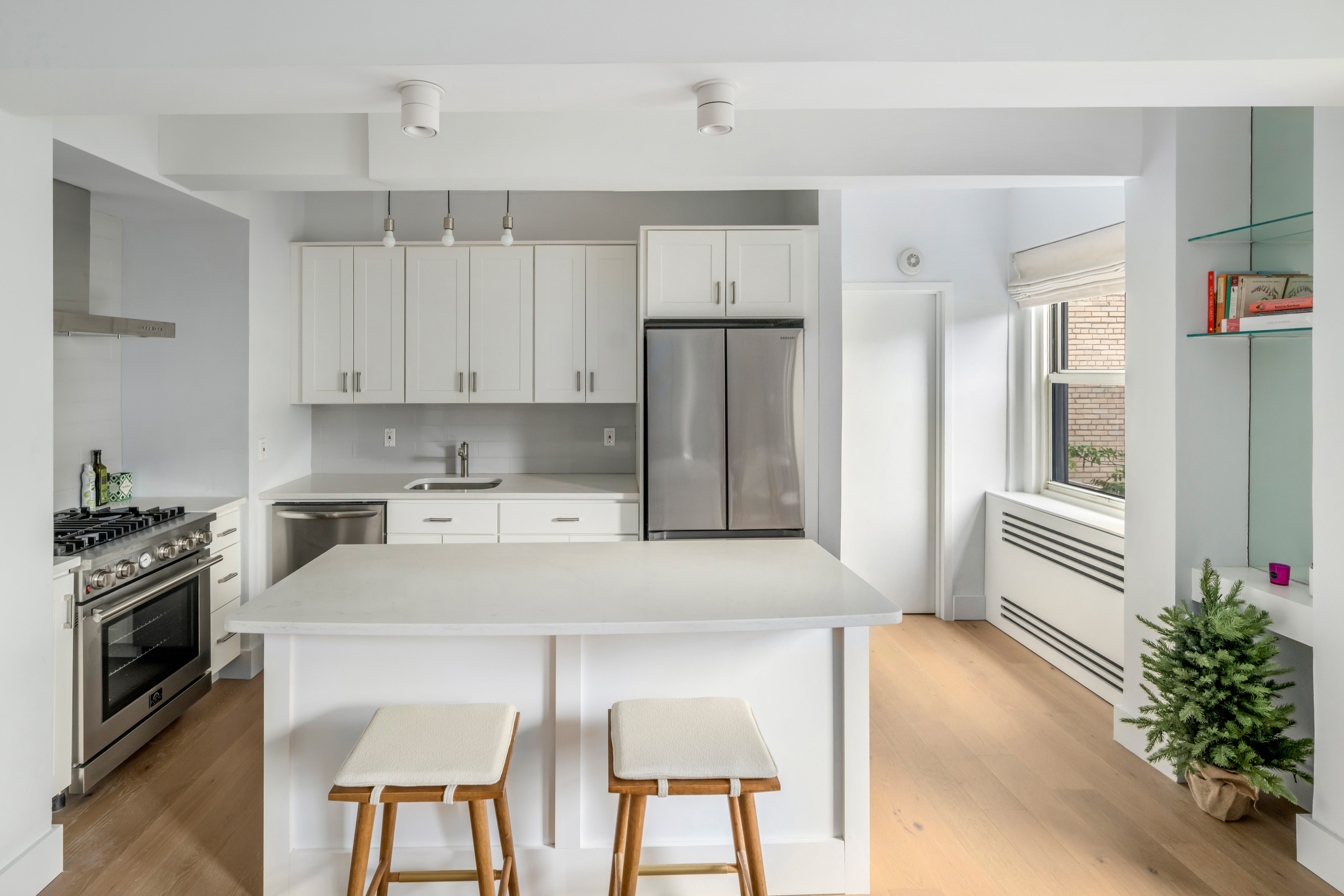 2166 Broadway, Unit 5C Manhattan, NY 10024 - Photo 3 of 11 a kitchen with a table chairs refrigerator and microwave