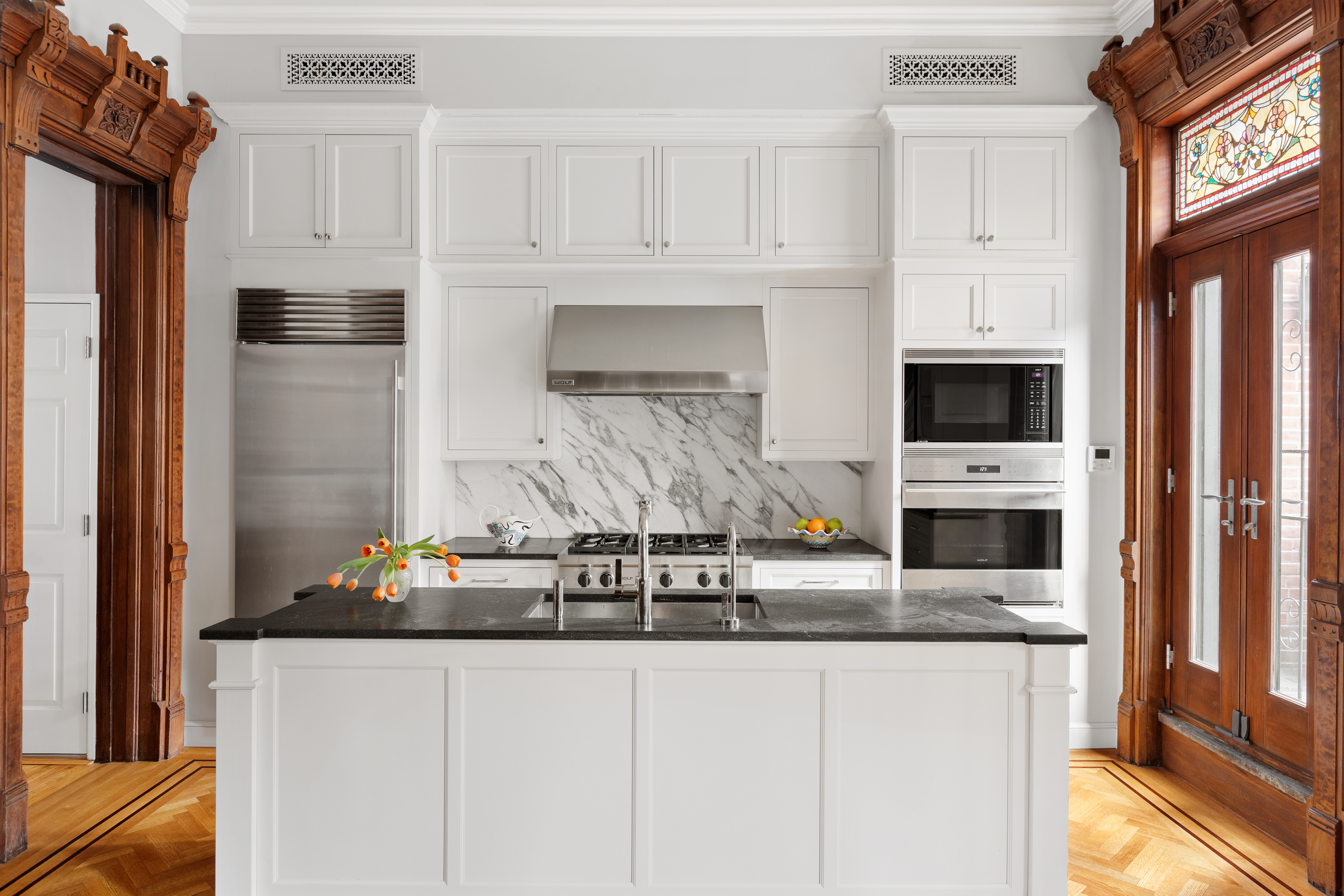 196 Berkeley Place Brooklyn, NY 11217 - Photo 8 of 25 a kitchen with stainless steel appliances granite countertop a stove a microwave and a refrigerator