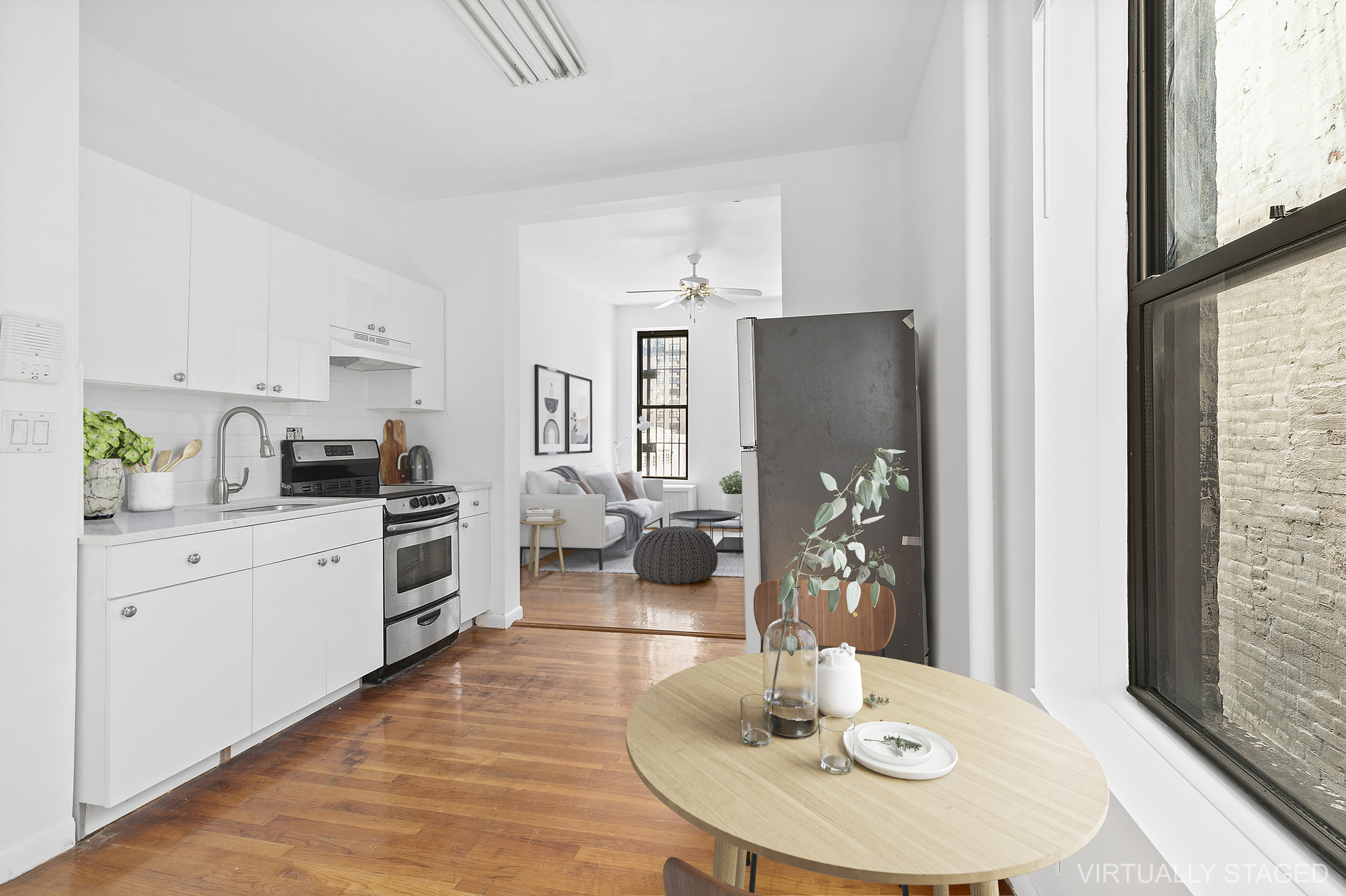 1315 3rd Avenue, Unit PH5RN Manhattan, NY 10021 - Photo 2 of 7 a kitchen with a refrigerator and stove top oven