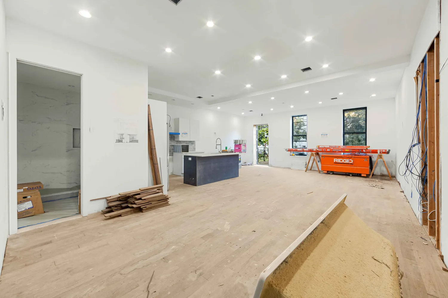 a room with a bed a gym equipment and a mirror