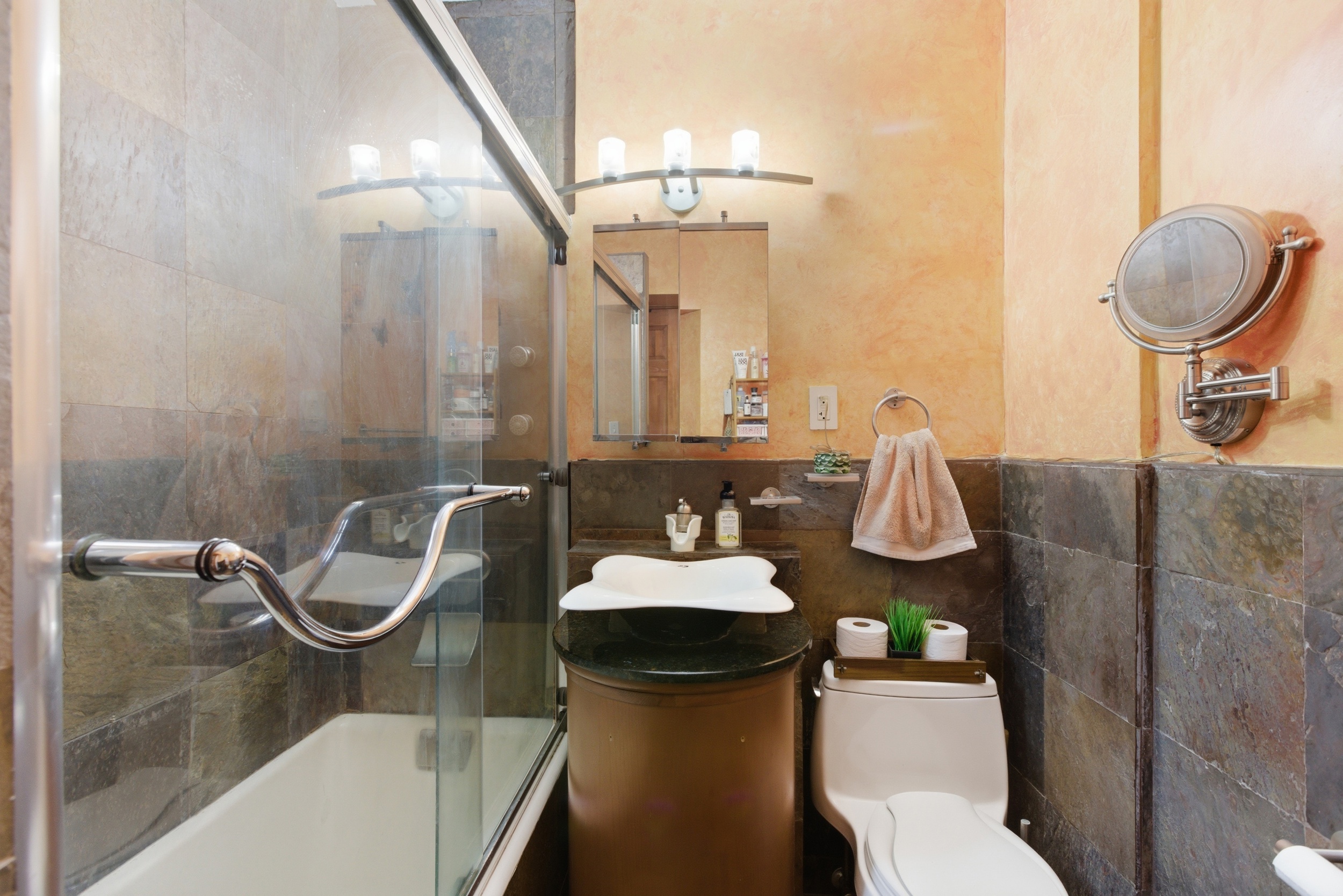 160 West 85th Street, Unit 6K Manhattan, NY 10024 - Photo 5 of 10 a bathroom with a sink toilet and a mirror