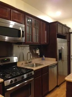 a kitchen with granite countertop a stove and a microwave