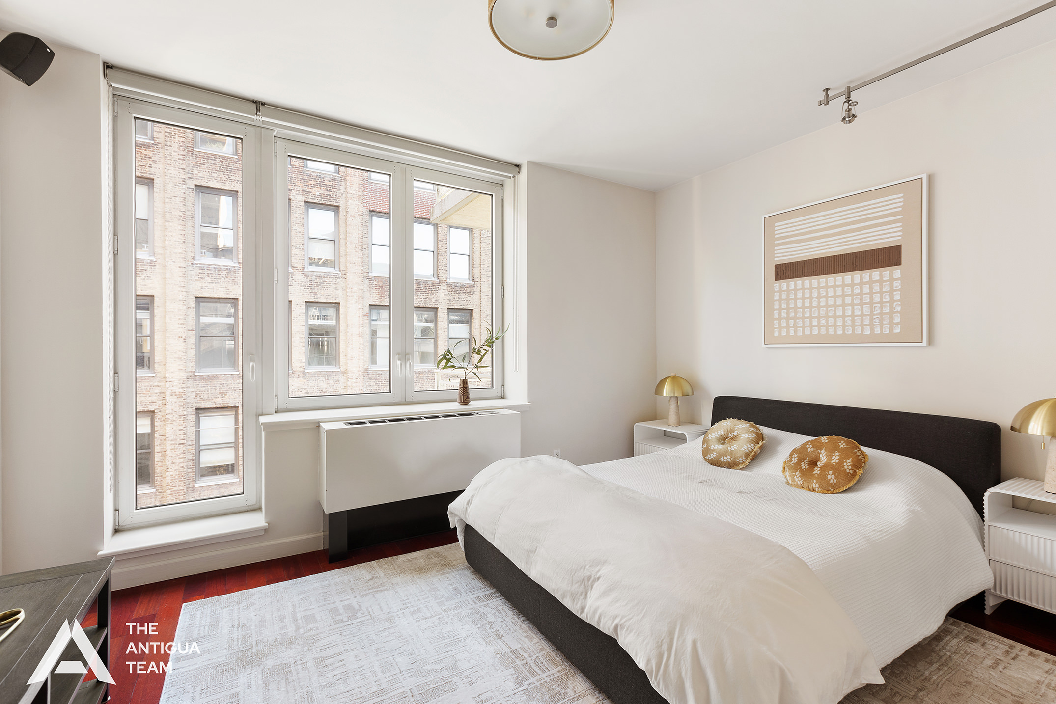 125 West 21st Street, Unit 12A Manhattan, NY 10011 - Photo 12 of 16 a bedroom with a bed and a window with outer view