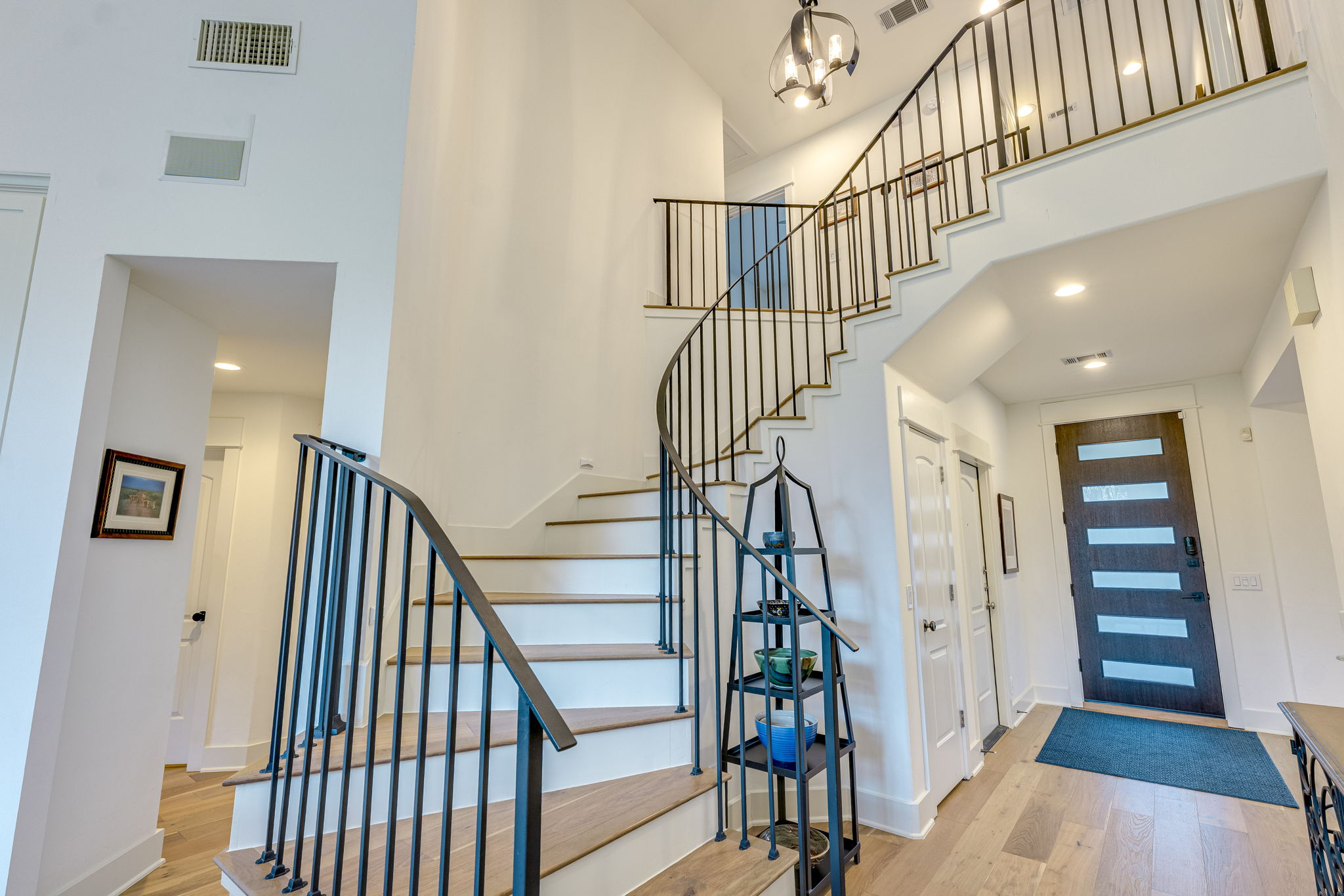 109 West Spring Drive Austin, TX 78746 - Photo 4 of 22 a view of entryway and hall with wooden floor
