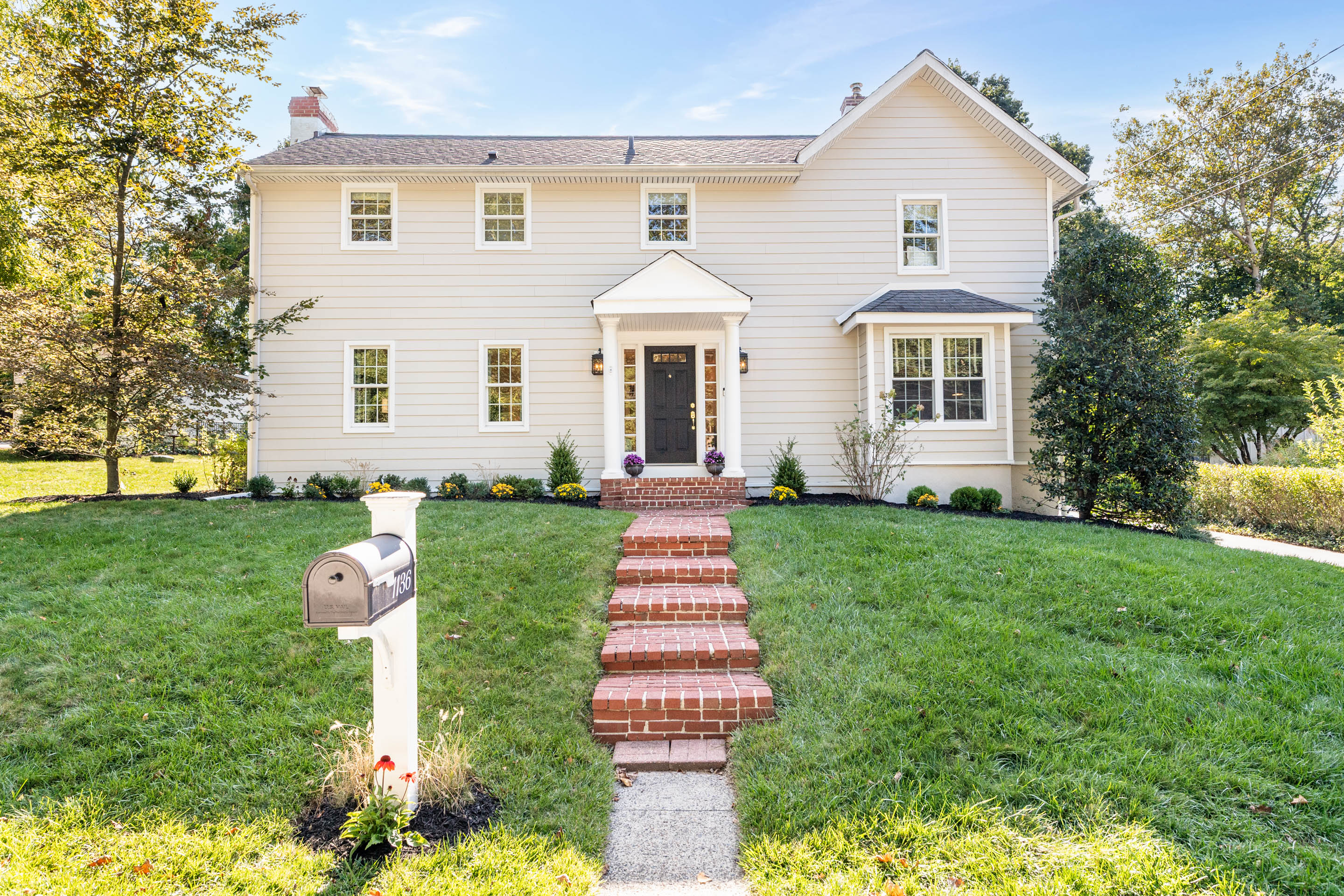 1136 Seaton Ross Road Wayne, PA 19087 - Photo 2 of 48 a front view of a house with a yard and trees