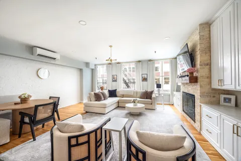 a large kitchen with a table and chairs