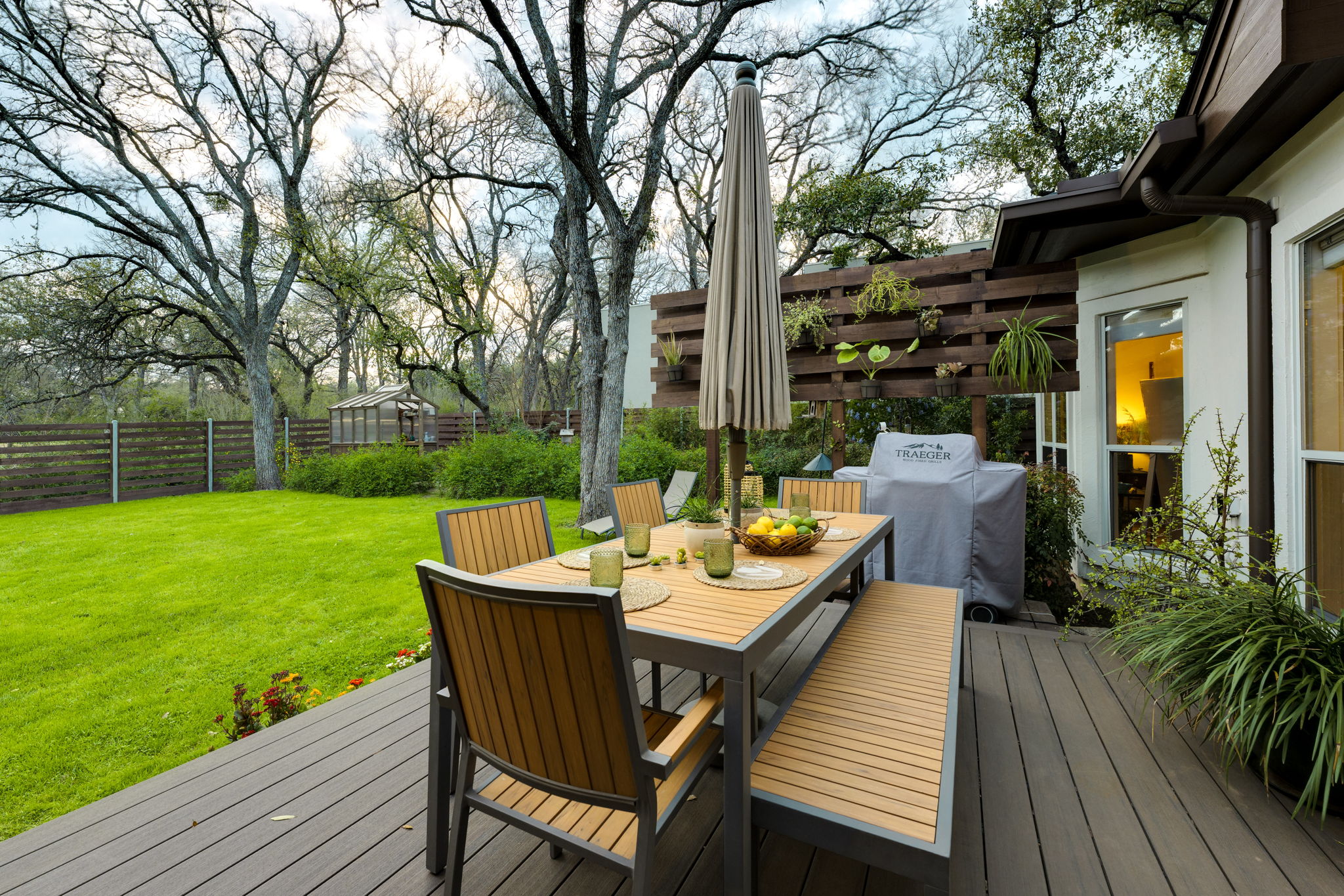 109 West Spring Drive Austin, TX 78746 - Photo 20 of 22 a view of a patio with a table chairs and a backyard