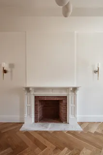 a view of an empty room with a closet and wooden floors