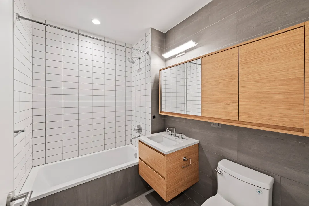 a bathroom with a sink a toilet and bathtub