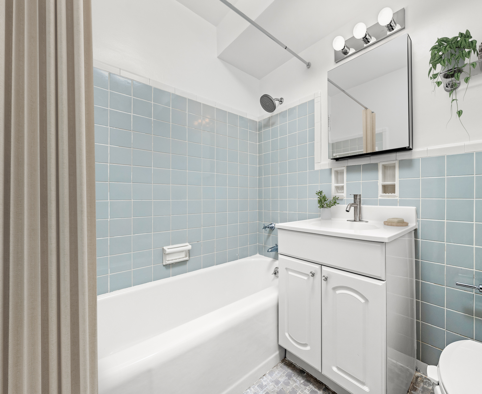 191 Willoughby Street, Unit 12N Brooklyn, NY 11201 - Photo 6 of 13 a bathroom with a sink a toilet a mirror and vanity