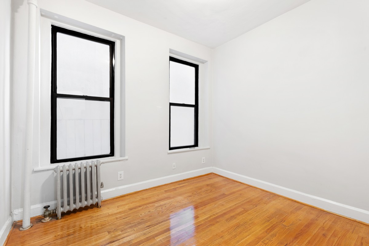 9 Spring Street, Unit 24 Manhattan, NY 10012 - Photo 4 of 8 an empty room with wooden floor and windows