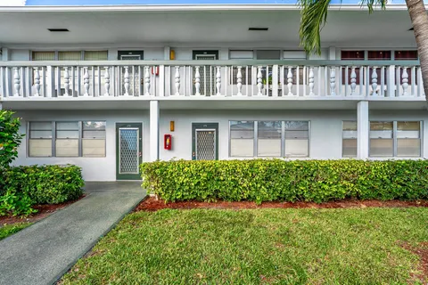 a front view of a house with garden and porch
