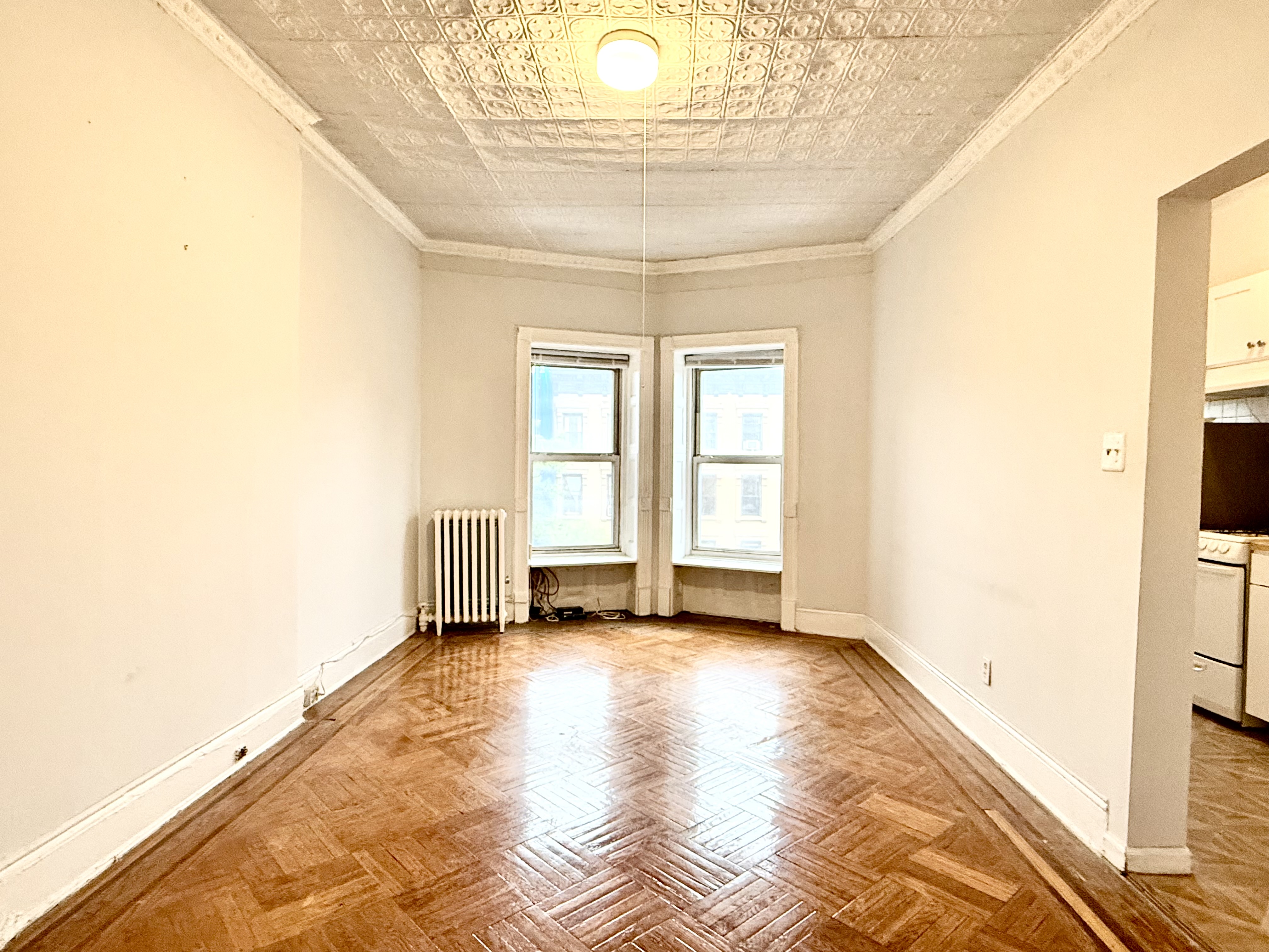 a view of a livingroom with wooden floor and a window