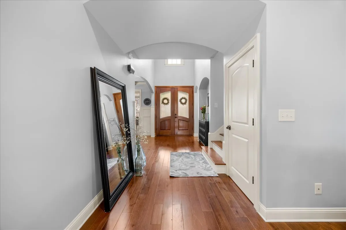 a living room with furniture a chandelier and a fireplace