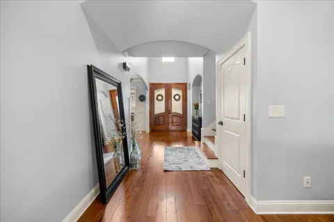 a living room with furniture a chandelier and a fireplace
