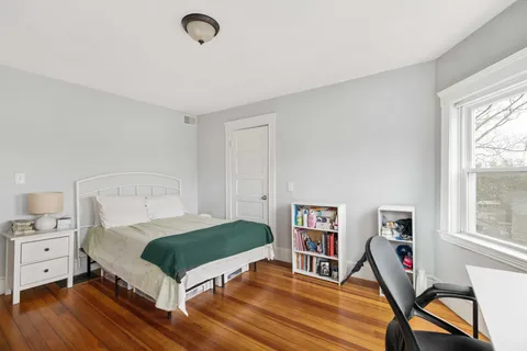 a bedroom with a bed and a bookshelf