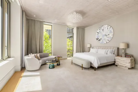 a spacious bedroom with a bed and a large window