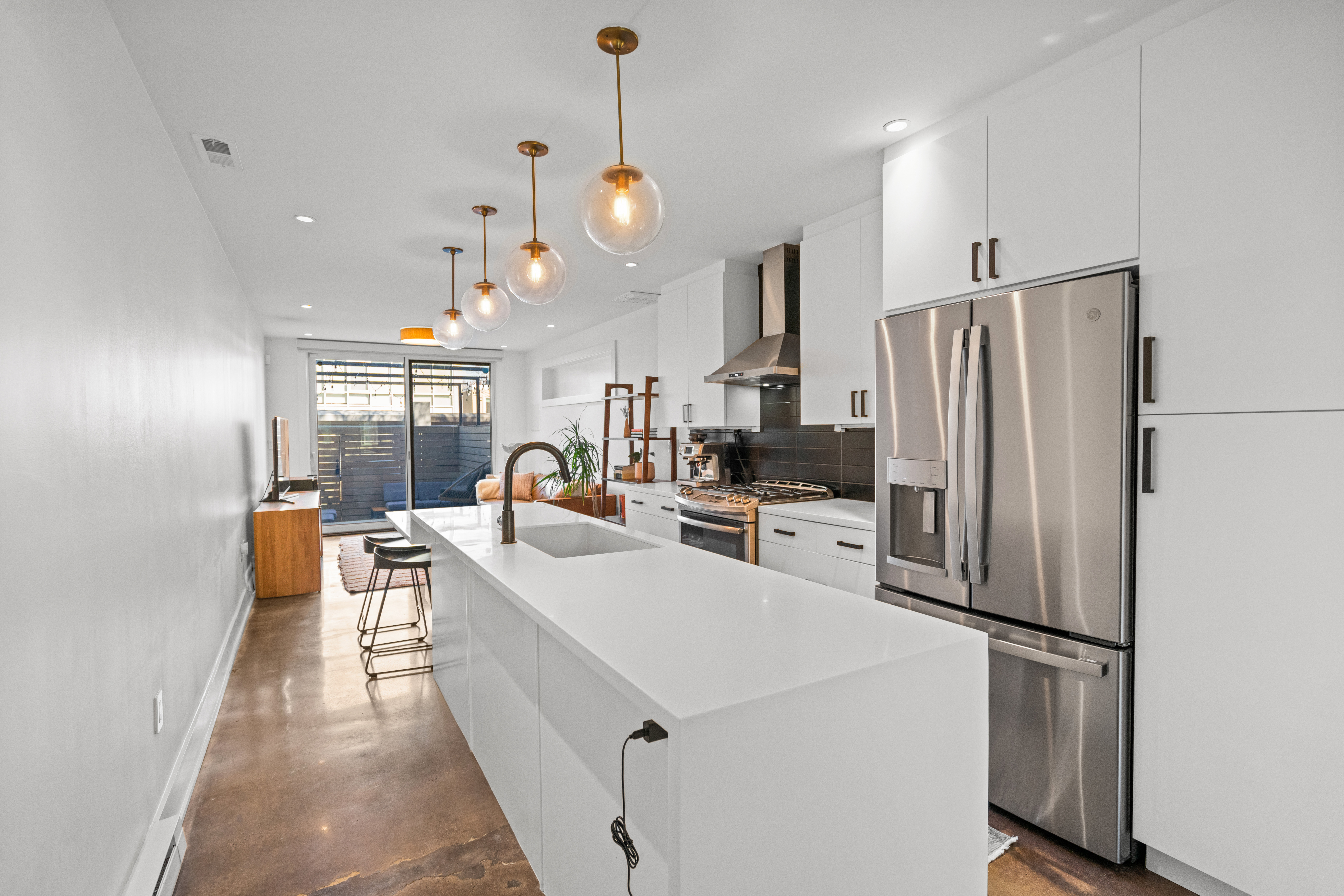 445 Ridge Street Northwest Washington, DC 20001 - Photo 9 of 43 a kitchen with stainless steel appliances a refrigerator a stove a sink dishwasher a oven and a dining table with wooden floor