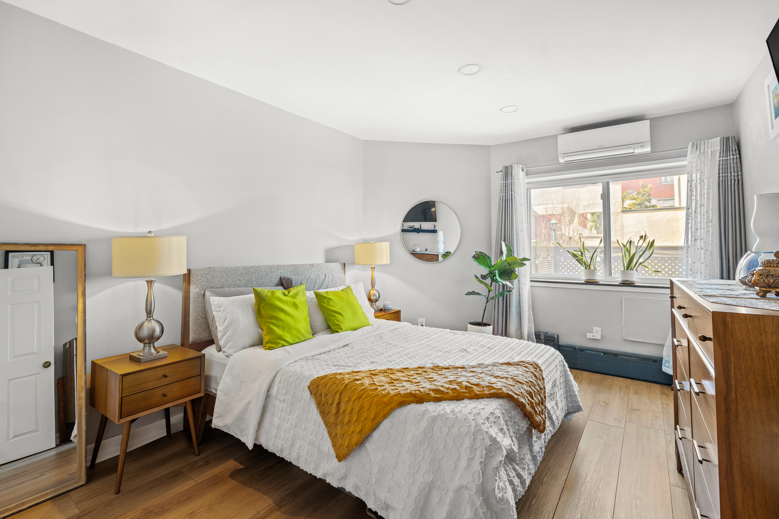 61-20 71st Avenue, Unit J1B Queens, NY 11385 - Photo 8 of 13 a bedroom with a bed a table and chair