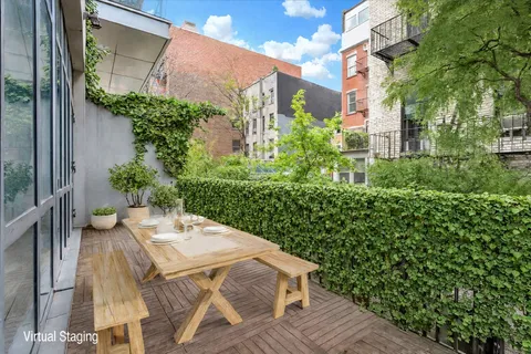 a view of a patio with table and chairs and potted plants