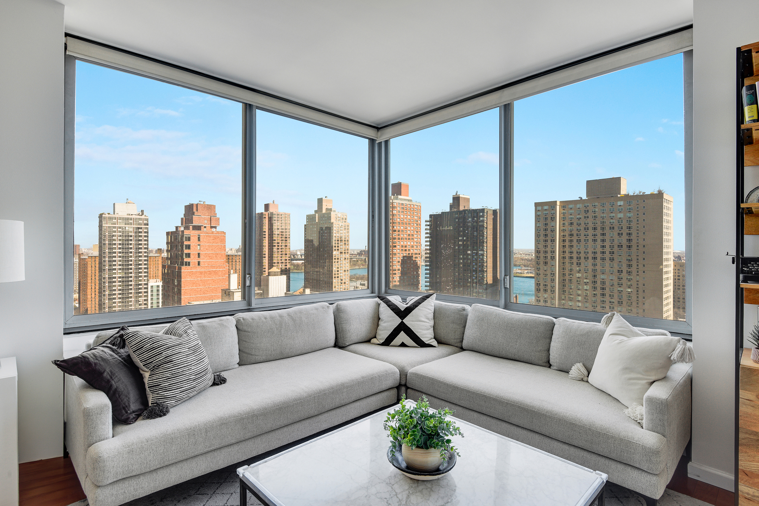 360 East 88th Street, Unit 22C Manhattan, NY 10128 - Photo 2 of 33 a living room with furniture and a large window