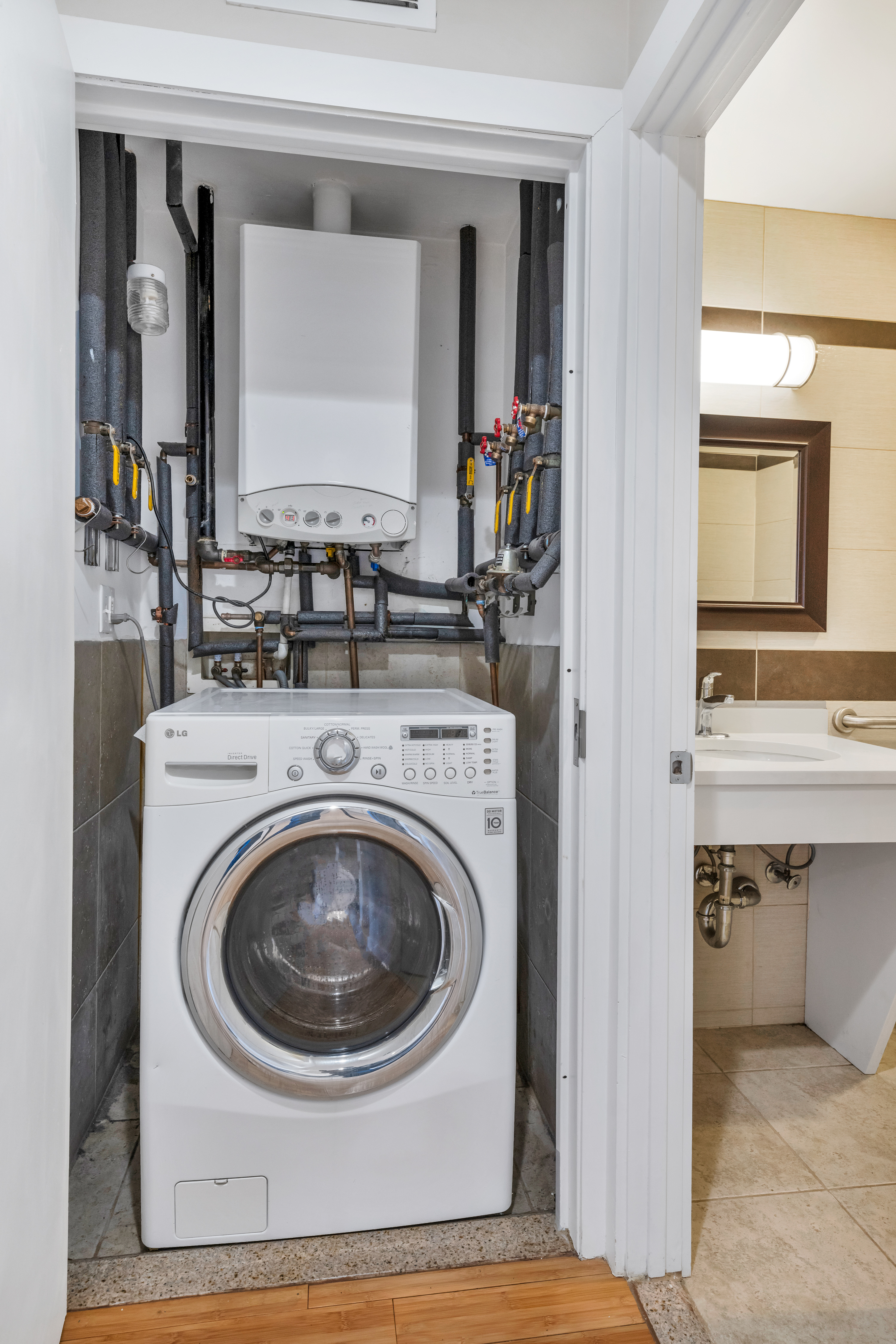 234 West 148th Street, Unit 5D Manhattan, NY 10039 - Photo 11 of 16 a utility room with sink dryer and washer