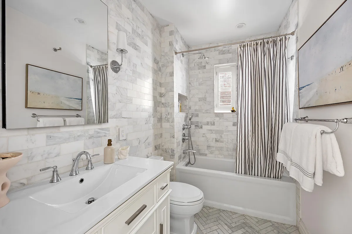 209 Clinton Street, Unit 4L Brooklyn, NY 11201 - Photo 14 of 17 a bathroom with a sink toilet and shower