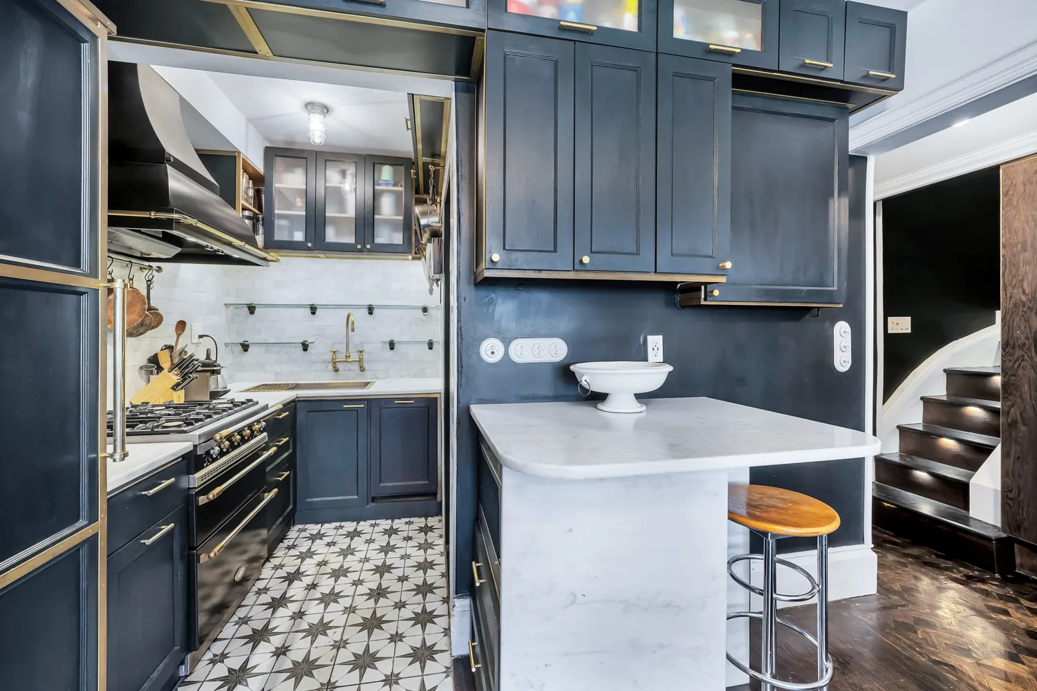 a kitchen with stainless steel appliances granite countertop a sink stove and cabinets