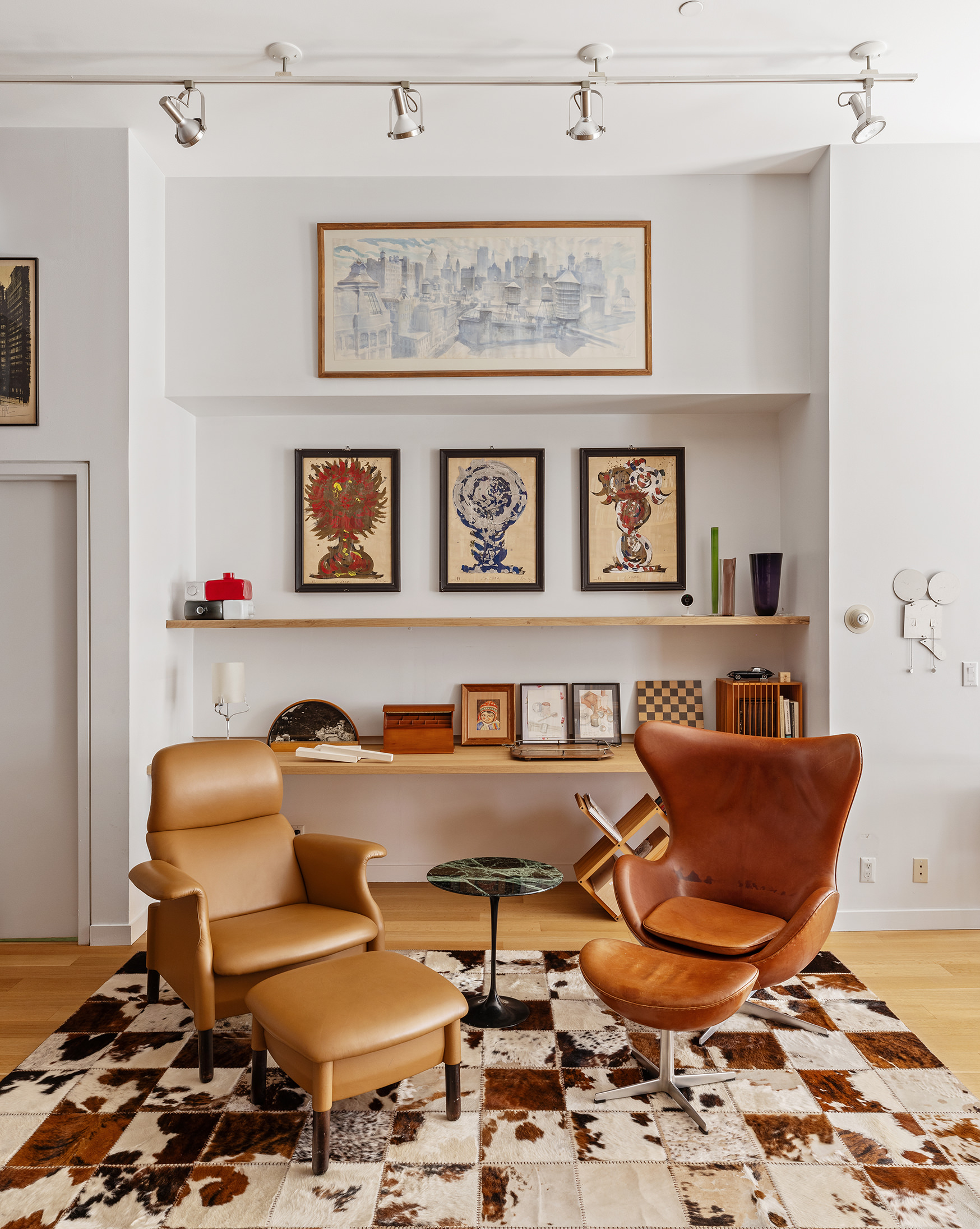 71 Ludlow Street, Unit 4B Manhattan, NY 10002 - Photo 7 of 15 a living room with furniture and paintings on the wall