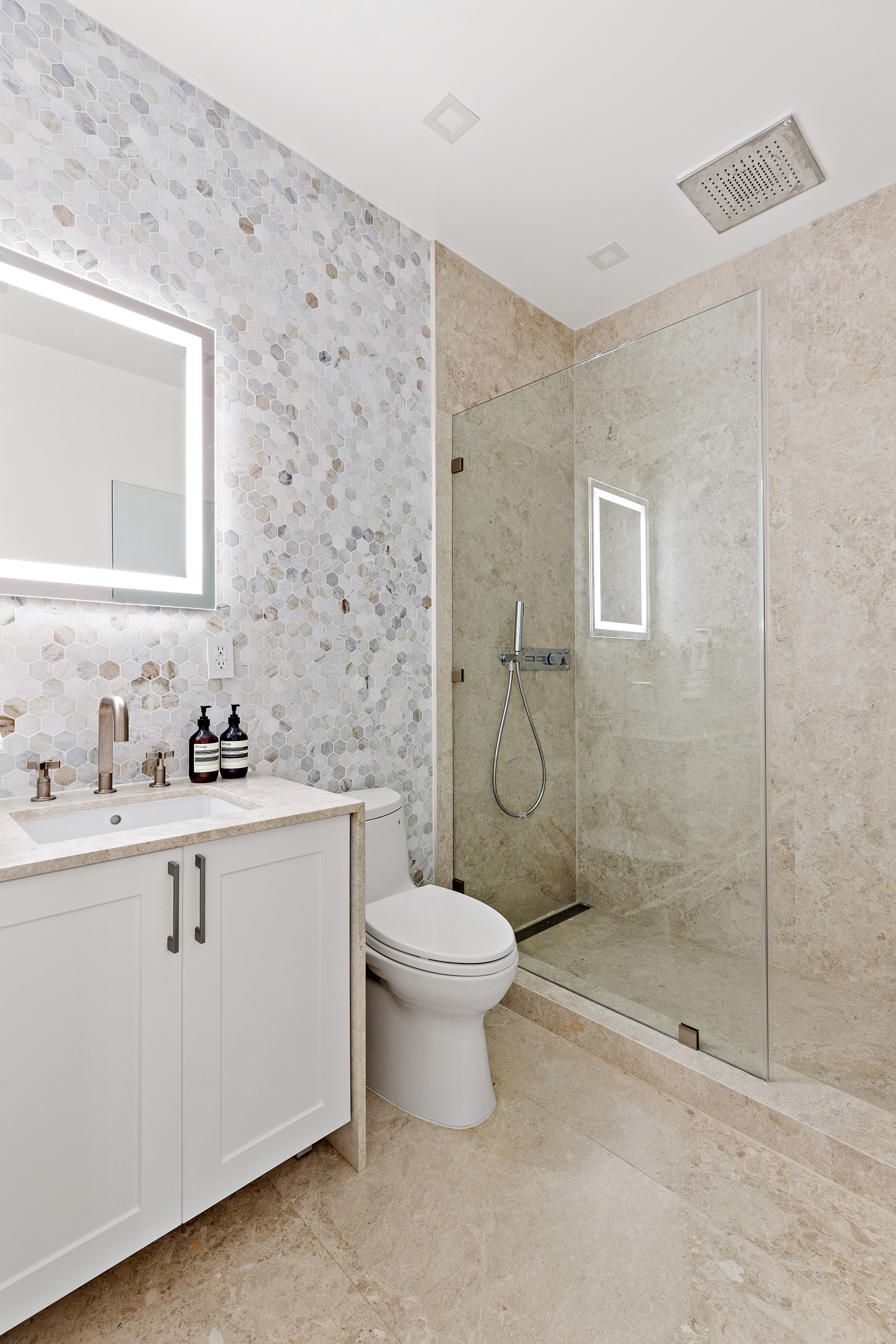 25 East 94th Street Manhattan, NY 10128 - Photo 20 of 33 a bathroom with a sink toilet and shower